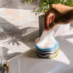 Hand Grabbing Bamboo Cotton Rounds In Bathroom