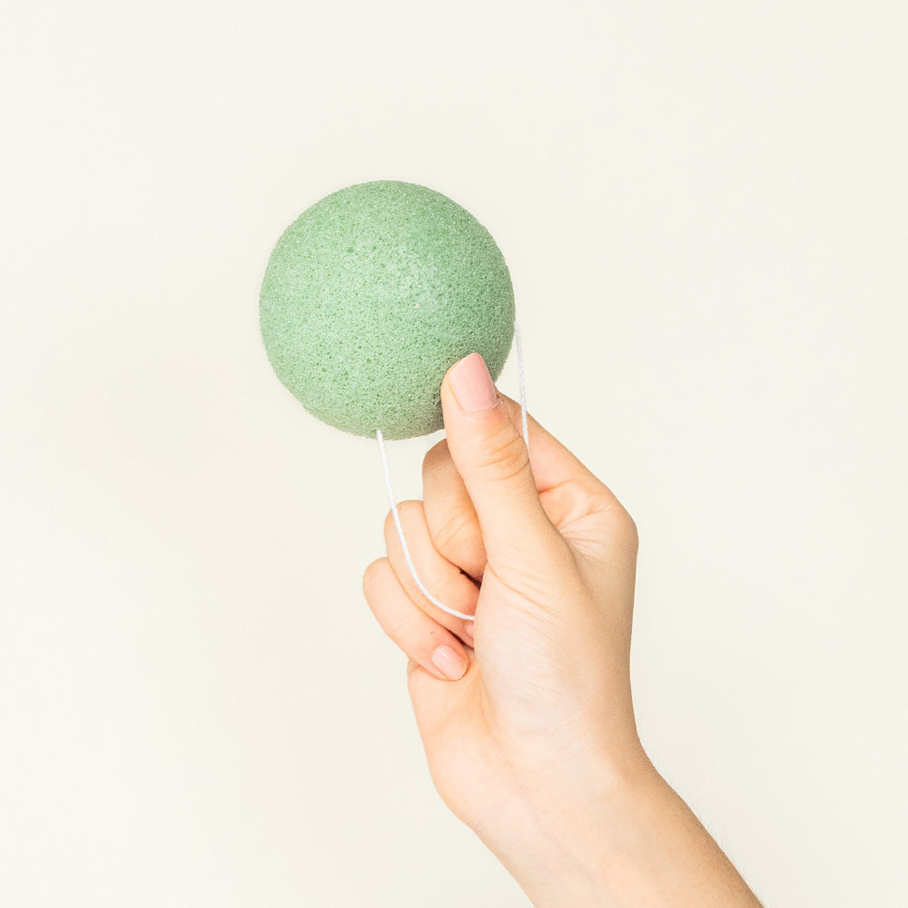 Holding Konjac Facial Sponge For Gentle Exfoliation